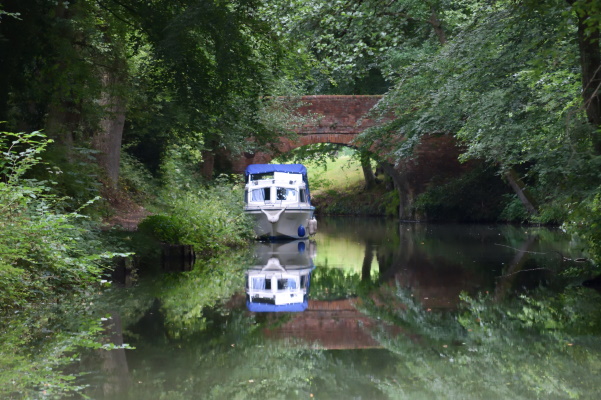Blue boat reflected in the water.